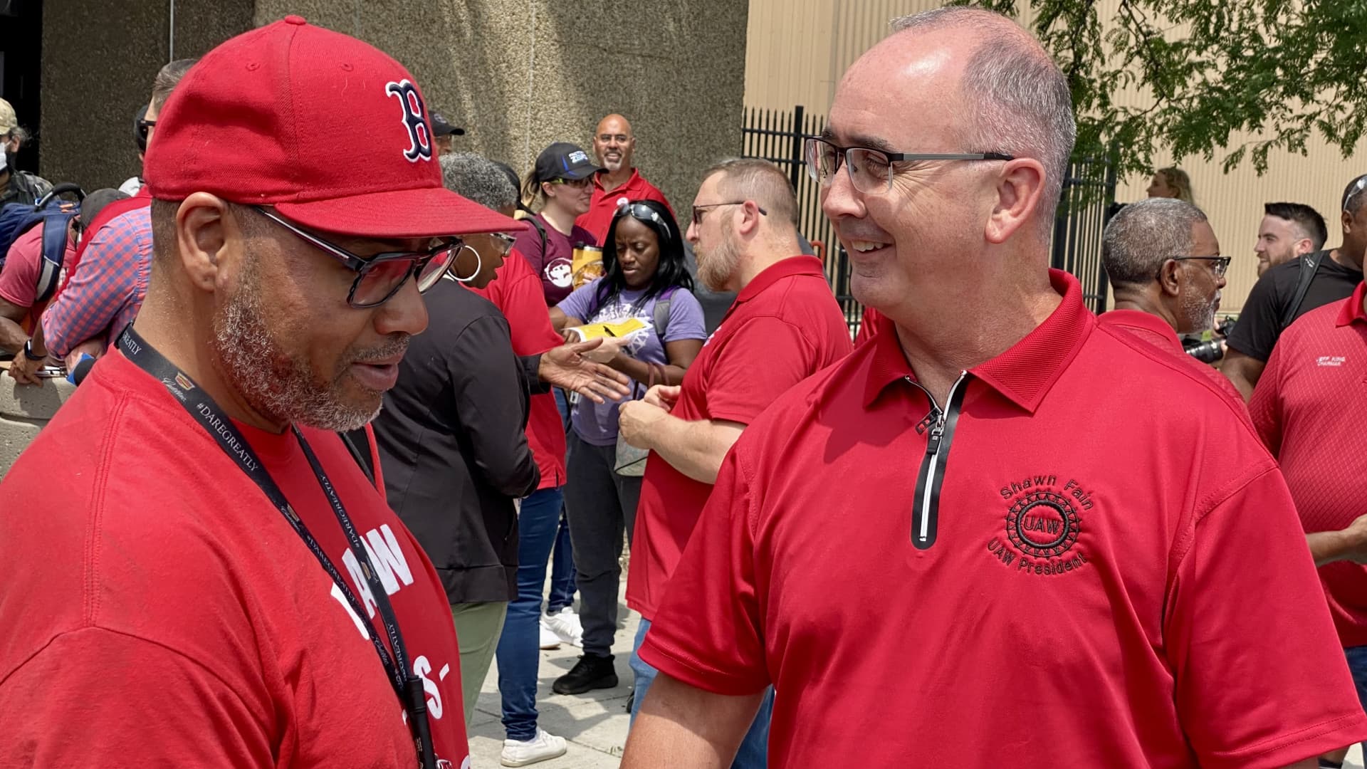 UAW President Shawn Fain (right) speaks with union member Jerome Buckley outside of General Motors' Factory Zero plant on July 12, 2023, in Detroit.