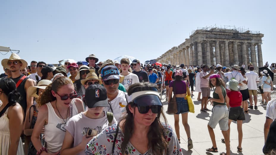 Atop the Acropolis ancient hill, tourists visit the Parthenon temple during a heat wave on July 20, 2023 in Athens, Greece. The Acropolis of Athens and other archaeological sites in Greece announced reduced opening hours due to the heatwave conditions.