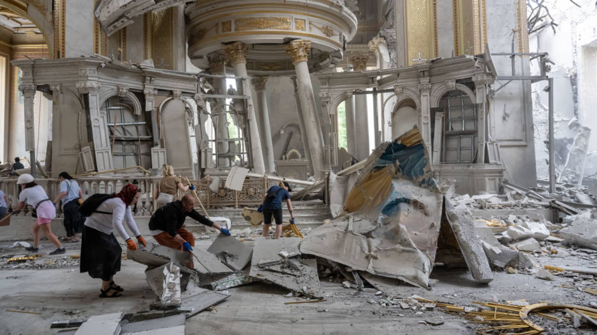 Ukrainians clear away debris after a Russian missile struck the historic Holy Transfiguration (Spaso-Preobrazhensky) Cathedral in central Odesa, Ukraine, on July 23, 2023.