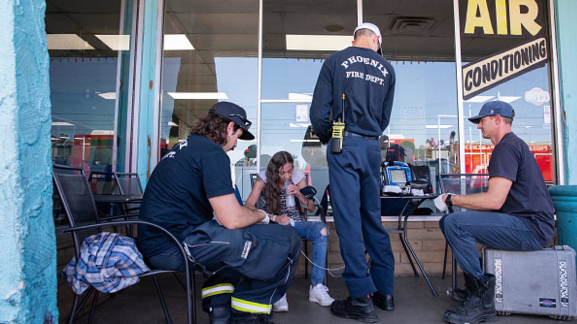 Phoenix Firefighters with Engine 18 check the vital signs of a resident called for help at a laundromat during a heat wave in Phoenix, Arizona, US, on Thursday, July 20, 2023. Phoenix extended its record streak of days above 110F to 20 on Wednesday with a high of 119F.