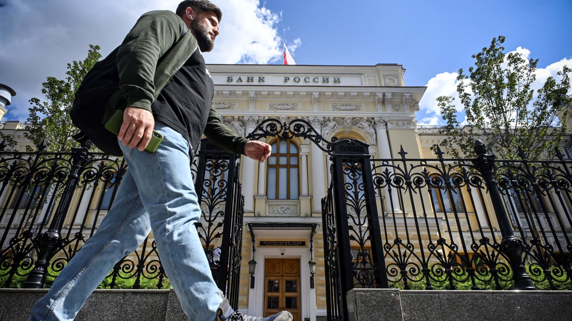 A man walks past the Russian Central Bank headquarters in downtown Moscow on July 21, 2023.