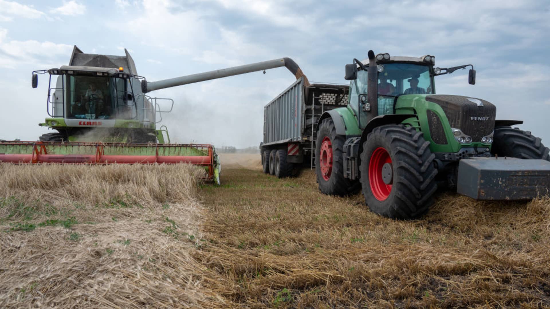 Farming vehicles harvest wheat during the harvesting season in Kharkiv region, Ukraine on July 26, 2023. 