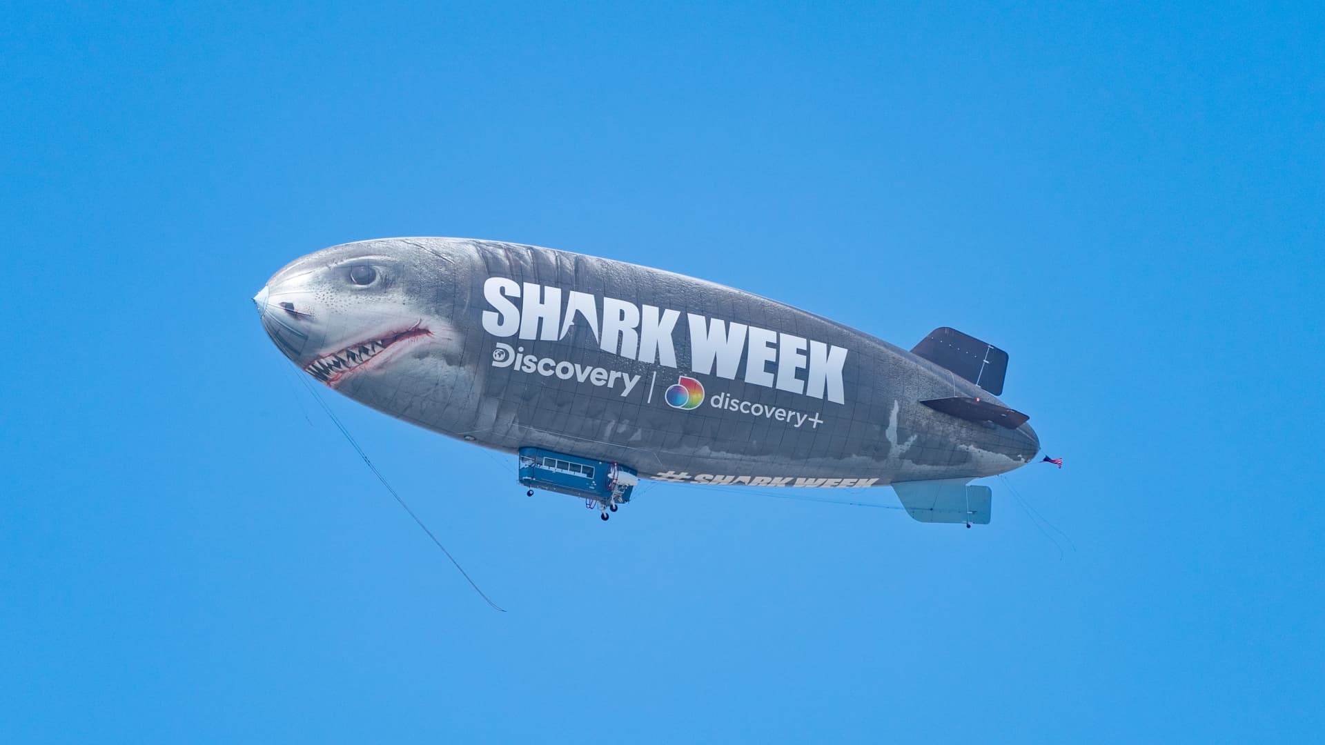 A 'Shark Week' blimp flies over the San Diego Convention Center on July 23, 2022.