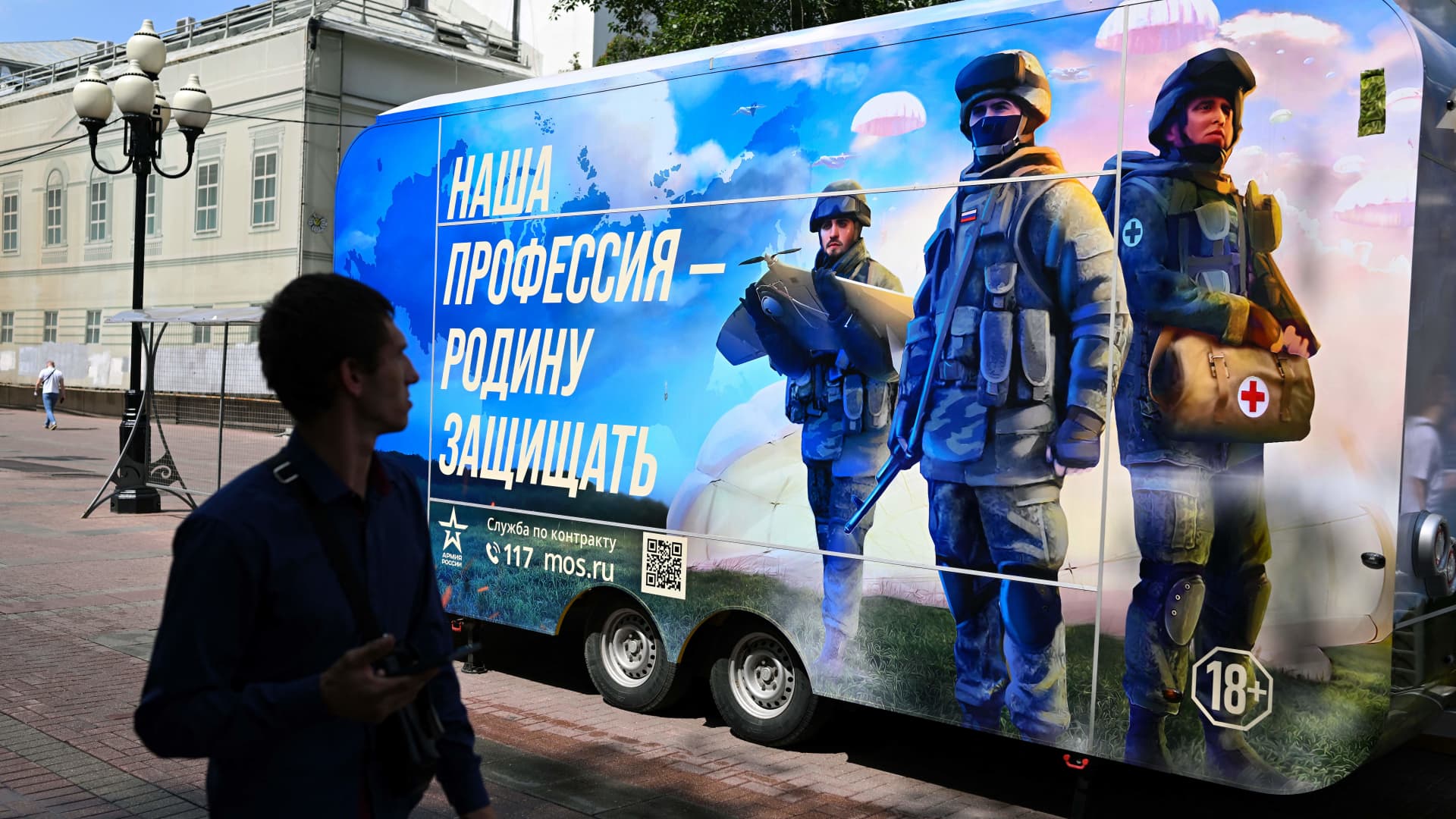 A man walks past a contract army service mobile recruitment point in Moscow on July 6, 2023.