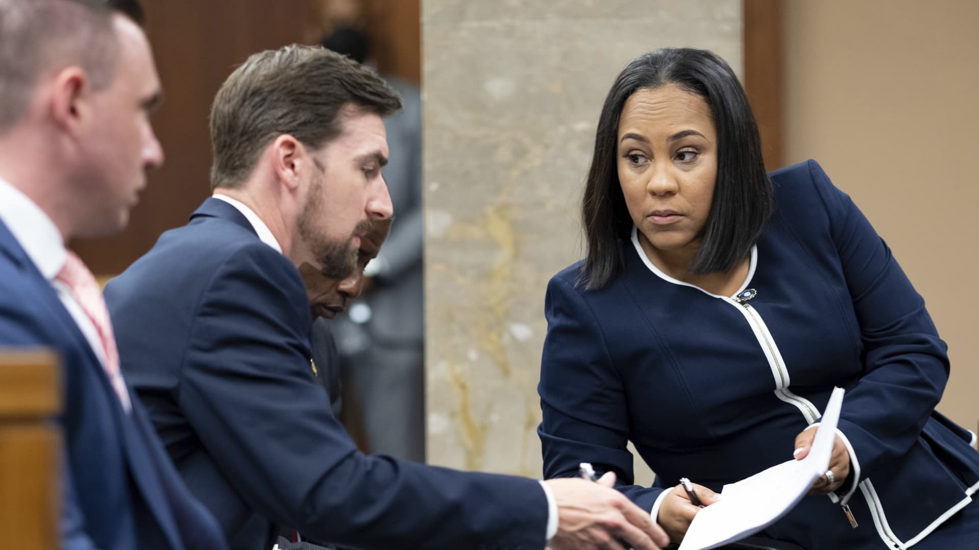 Fulton County District Attorney Fani Willis, right, talks with a member of her team during proceedings to seat a special purpose grand jury in Fulton County, Georgia, on May 2, 2022, to look into the actions of former President Donald Trump and his supporters who tried to overturn the results of the 2020 election.