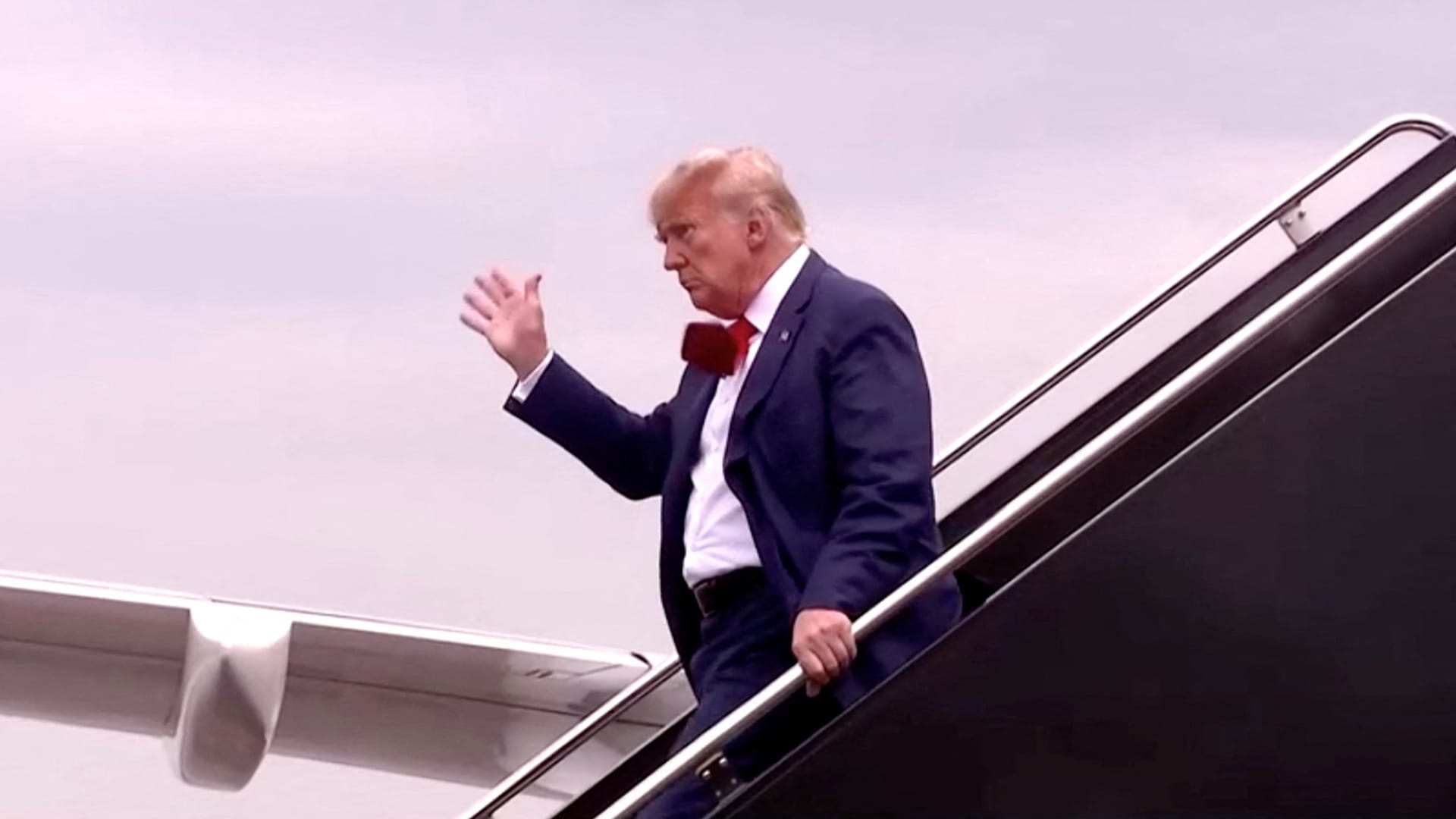 Former U.S. President Donald Trump, who is to appear in a federal court facing federal charges related to attempts to overturn his 2020 election defeat, waves as he arrives in this still image taken from video at Reagan Washington National Airport in nearby Arlington, Virginia, U.S., August 3, 2023. 
