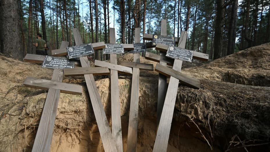 Crosses are pictured in a graveyard on August 8, 2023 in the forest near Izyum, Kharkiv region, were 449 local residents and Ukrainian prisoners were buried before being reburied in the city official cemetery after the Russian occupation of the town. The town in eastern Ukraine, which had some 45,000 residents before the invasion, was reclaimed by Ukrainian forces in September 2022 after being occupied by Russia in the first months of the war. (Photo by SERGEY BOBOK / AFP) (Photo by SERGEY BOBOK/AFP via Get