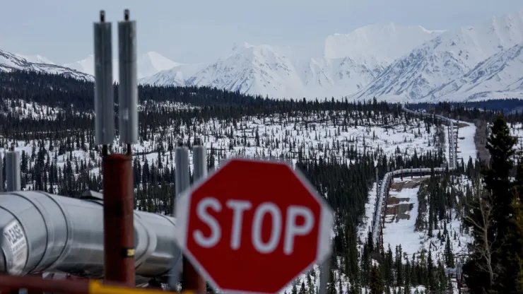 DELTA JUNCTION, ALASKA - MAY 05: A part of the Trans Alaska Pipeline System runs through boreal forest past Alaska Range mountains on May 5, 2023 near Delta Junction, Alaska. The 800-mile-long pipeline carries oil from the North Slope in Prudhoe Bay to the port of Valdez. In March, the Biden administration approved the controversial Willow project which will extract 600 million barrels of oil from the National Petroleum Reserve on Alaska’s North Slope, close to the Arctic Ocean. (Photo by Mario Tama/Getty