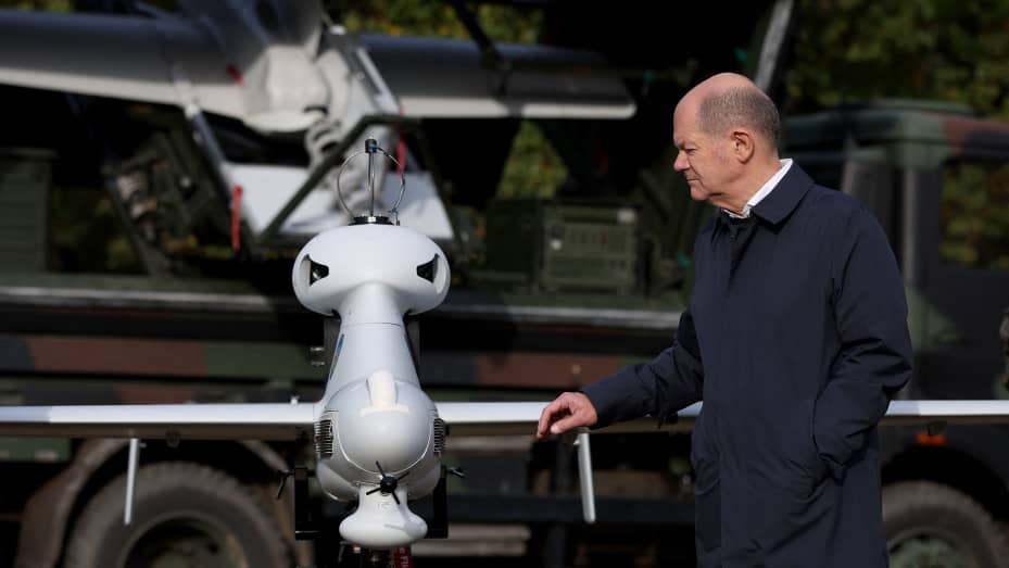 German Chancellor Olaf Scholz next to a Luna surveillance drone in Ostenholz, northern Germany, on Oct. 17, 2022.