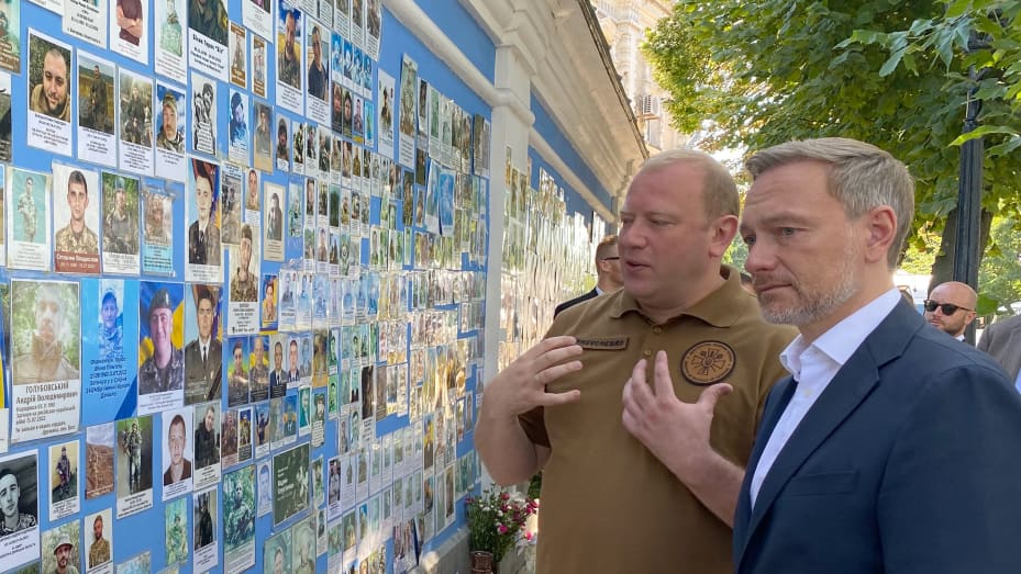 German Finance Minister Christian Lindner next to Ukrainian Deputy Defense Minister Andriy Shevchenko at the wall of St. Michael's Monastery, where he laid a wreath in memory of soldiers killed in the war.