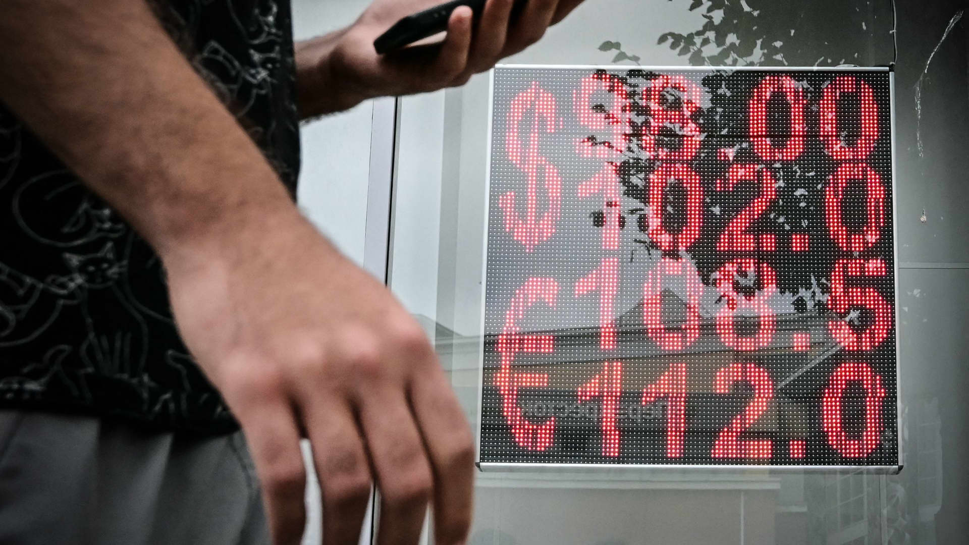 A man walks past a currency exchange office in Moscow on August 14, 2023. 