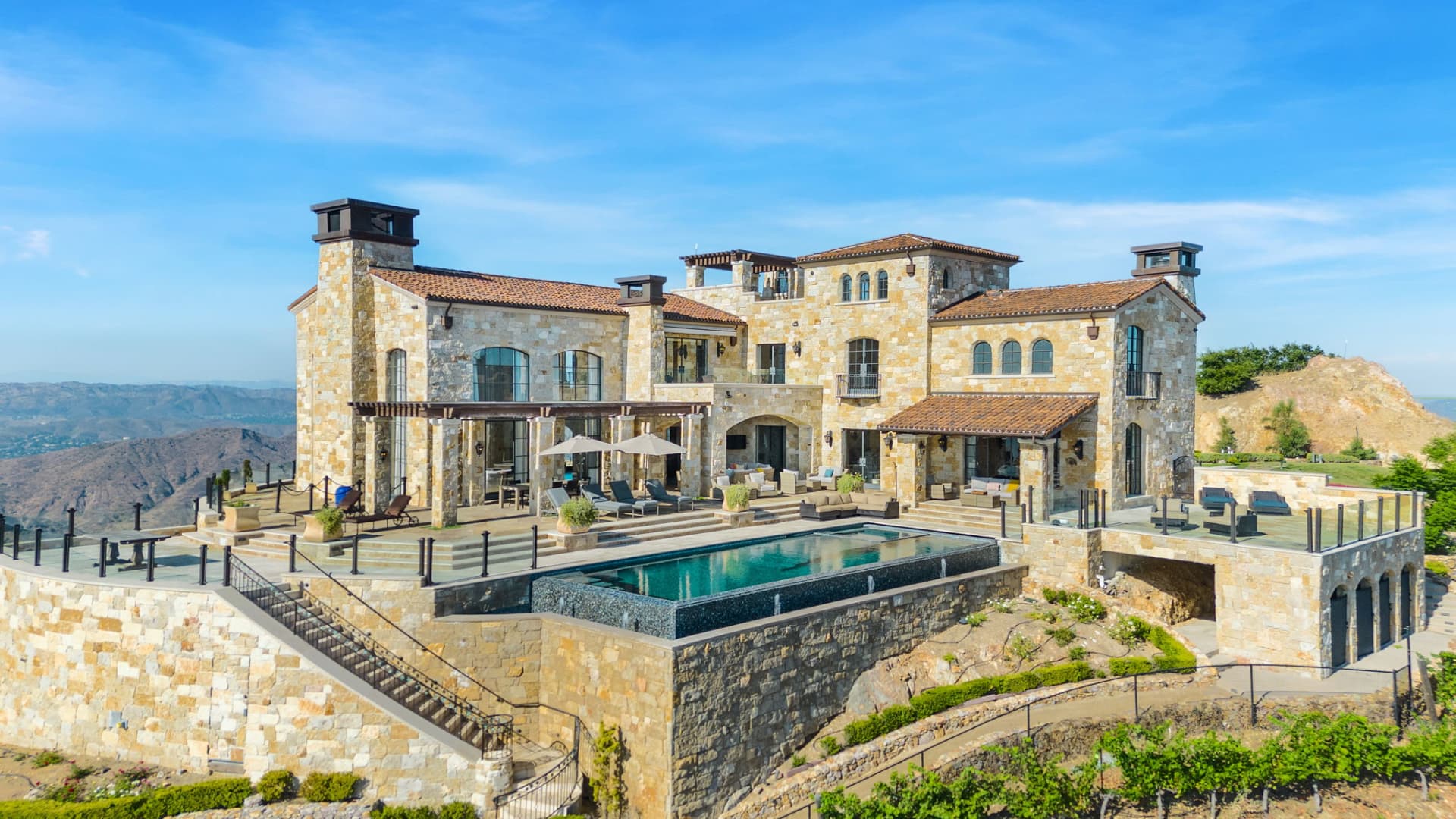 A view of the stone-clad villa's sundeck and infinity pool.