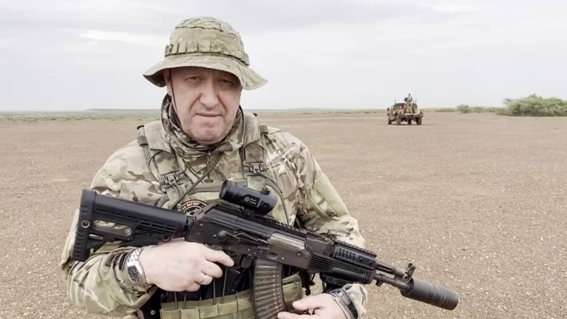 A screen grab captured from a video shared online shows Yevgeny Prigozhin, the founder of the Russian private security company Wagner, holding a rifle in a desert area while wearing camouflage in a video for the first time after his rebellion against the Russian administration in an unspecified location in Africa on August 21, 2023. In the footage shared on the Telegram channel 'Wagner's evacuation', Prigozhin stated that they have made Russia 'even greater' on all continents, including Africa. 