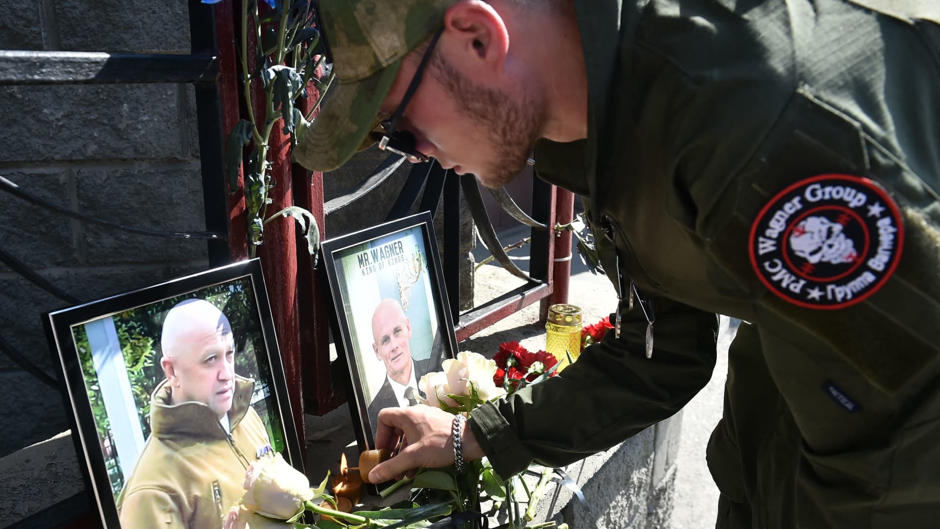 A member of private mercenary group Wagner pays tribute to Yevgeny Prigozhin and Dmitry Utkin following their apparent deaths in a plane crash on Aug. 23, 2023.