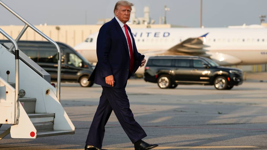 Former President Donald Trump steps off his plane as he arrives at Hartsfield-Jackson Atlanta International Airport, Thursday, Aug. 24, 2023, in Atlanta.
