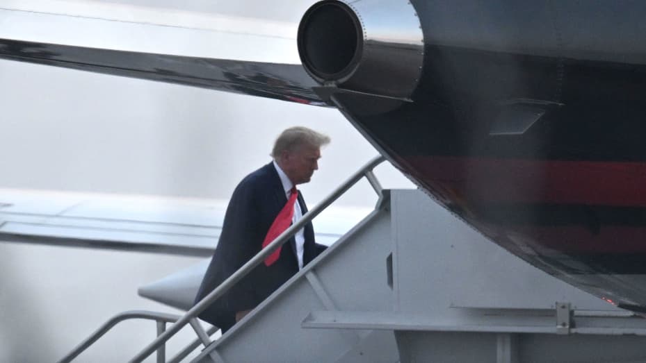 Former US President Donald Trump boards his plane Trump Force One as he departs Atlanta Hartsfield-Jackson International Airport in Atlanta, Georgia, on August 24, 2023. Former US president Donald Trump was photographed for a police mug shot after his arrest on August 24 at the Fulton County Jail in Georgia, multiple US media outlets reported citing local officials. The picture, which has yet to be released, is set to become a world-famous image as Trump fights multiple criminal cases at the same time as ru