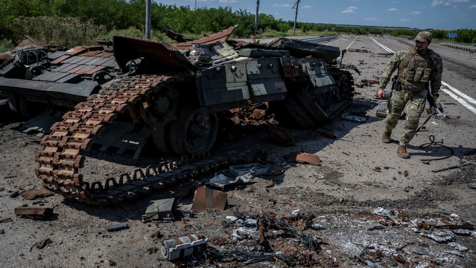 A Ukrainian serviceman walks near a destroyed Ukrainian tank, as Russia's attack on Ukraine continues, near the village of Robotyne, Zaporizhzhia region, Ukraine, on Aug. 25, 2023.