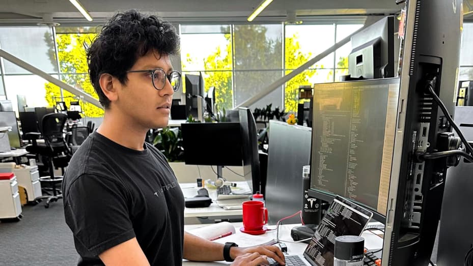 Dhaval Shroff works at his desk at Tesla.
