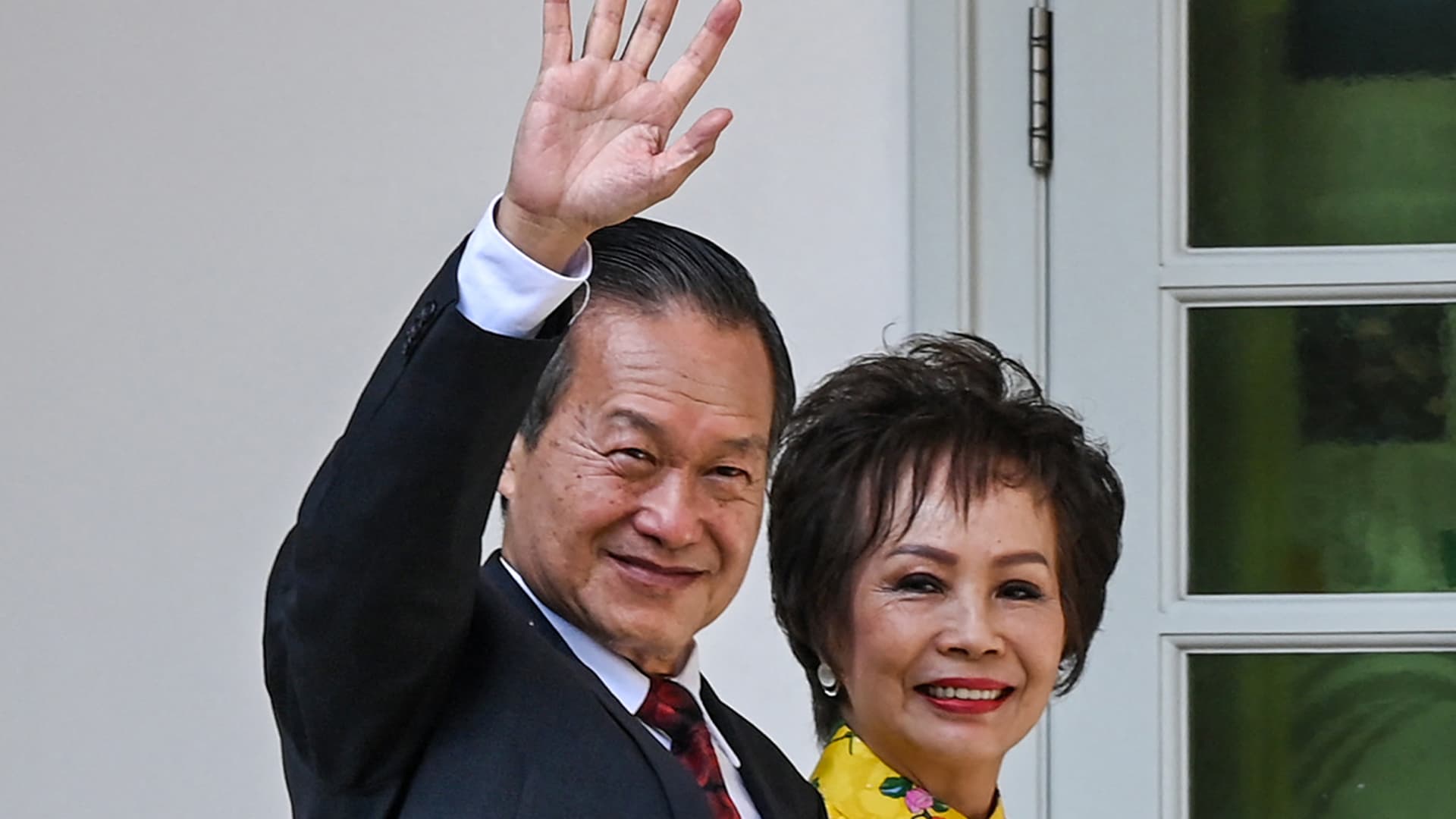 Presidential candidate Tan Kin Lian (left) waves as he arrives at the nomination center for the presidential election in Singapore on August 22, 2023.