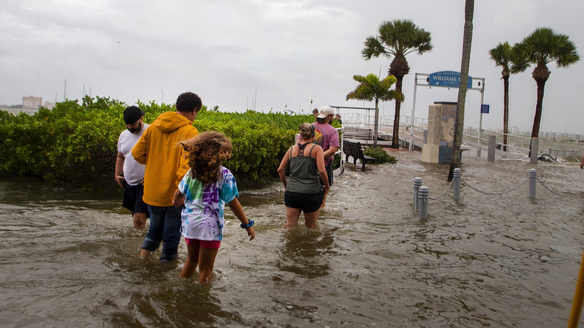Residents walk through floodwaters from Hurricane Idalia in Gulfport, Florida, on Wednesday, Aug. 30, 2023.