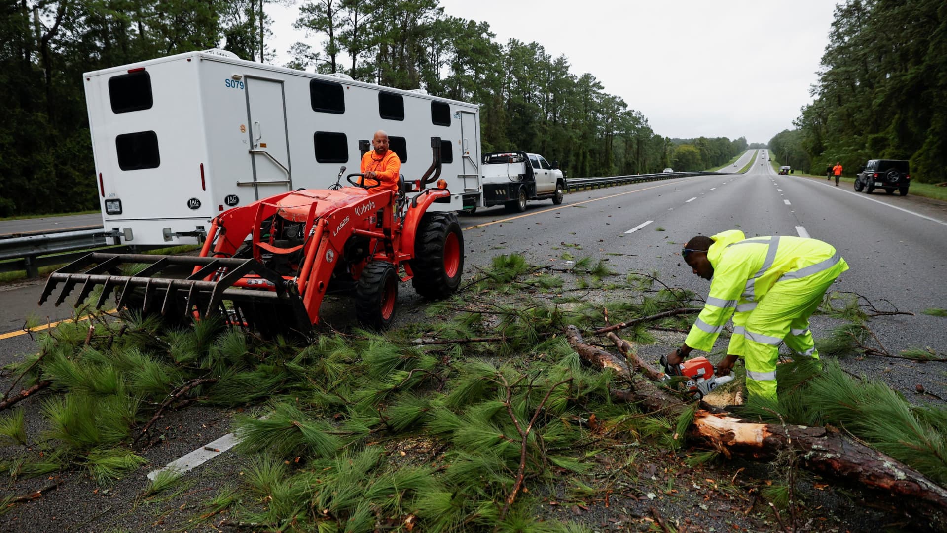 Workers clean up a blockade at Interstate 75 (I-75) highway after the arrival of Hurricane Idalia, near Gainesville, Florida, August 30, 2023.