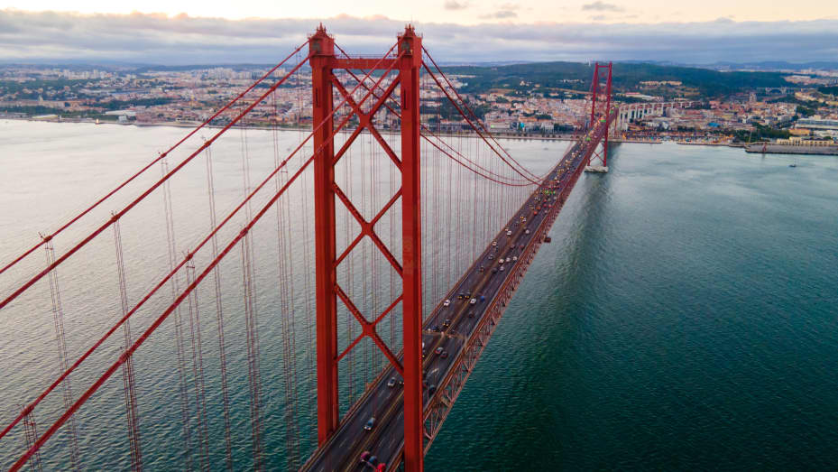 Aerial view shot of the April 25th Bridge and the Tagus River at sunset, Almada, Lisboa Region, Portugal