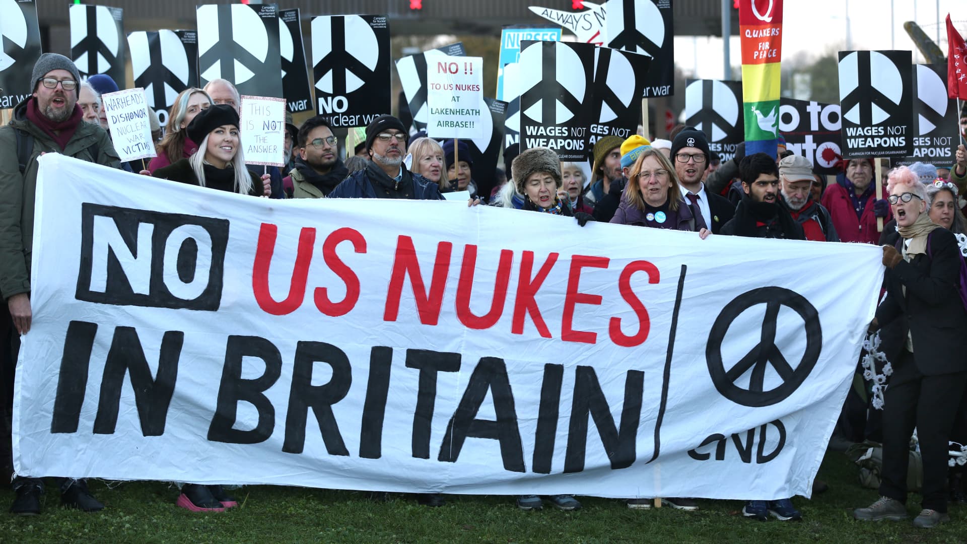 Protesters gather outside the air force base behind a large 'No Nukes in Britain' banner on November 19, 2022 in Lakenheath, England.