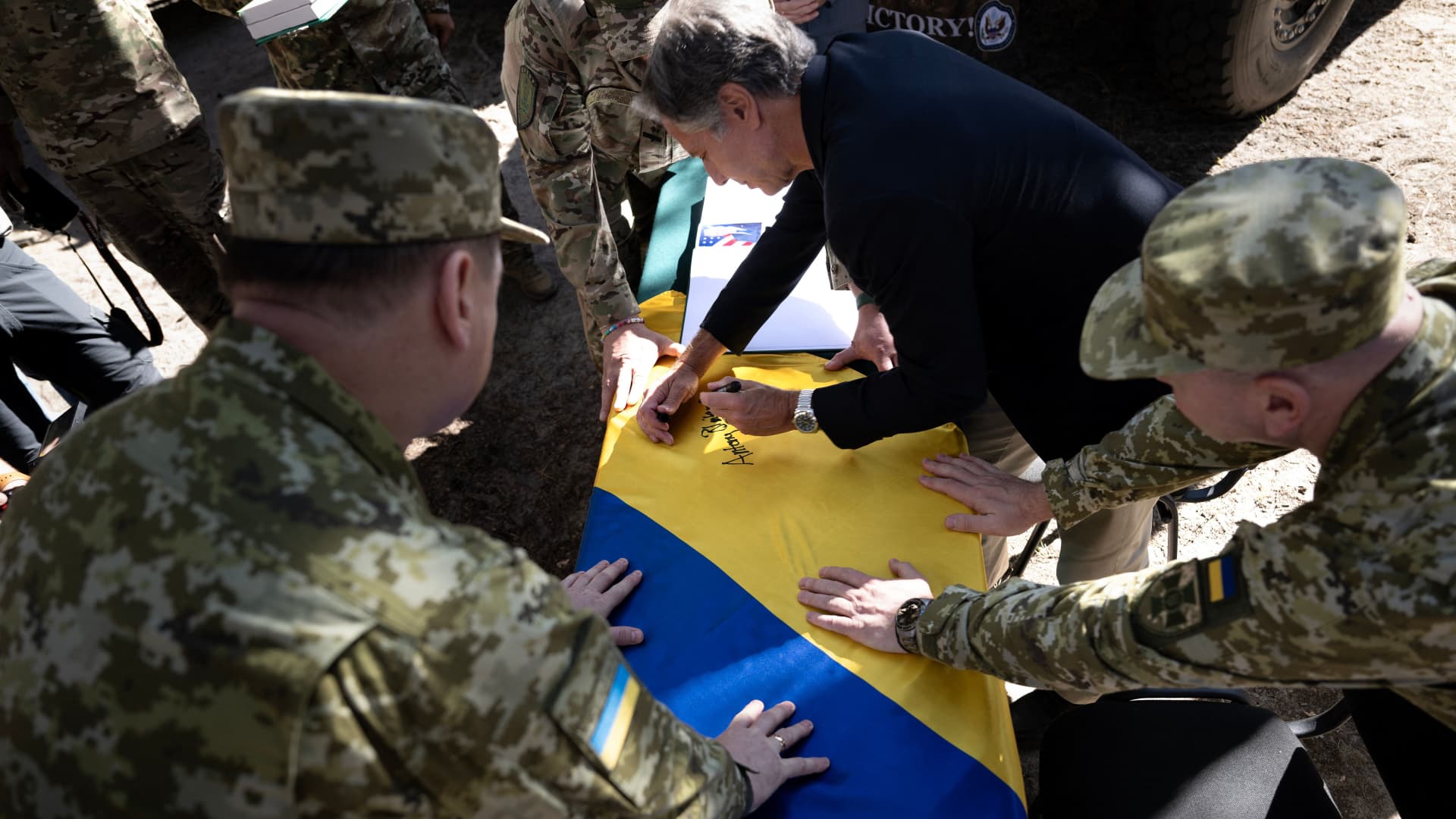 Secretary of State Antony Blinken signs a flag while touring a State Border Guard of Ukraine Detached Commandant Office of Security and Resource Supply site September 7, 2023, in theKyiv Oblast. 