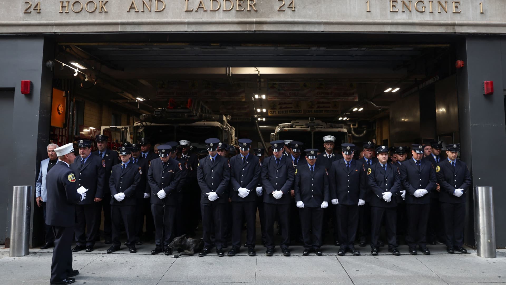Firefighters from Hook and Ladder 24 Engine 1 fire station in New York City observe a moment of silence on the 22nd anniversary of the 9/11 attacks, Sept. 11, 2023.