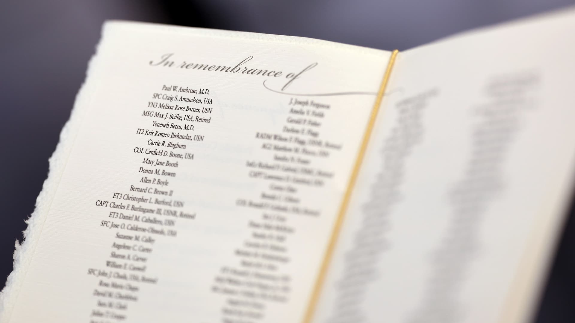 Victim's names are seen in a program during a ceremony observing the 22nd anniversary of the 9/11 terrorist attacks at the Pentagon, in Arlington, Virginia, Sept. 11, 2023.