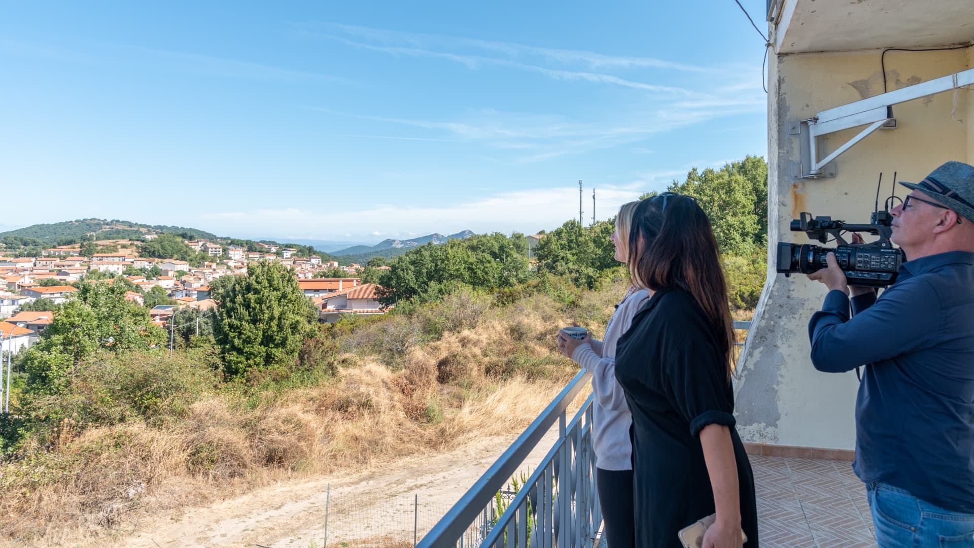 Partis overlooks the view from her balcony, with Veronica Matta, who is overseeing the 