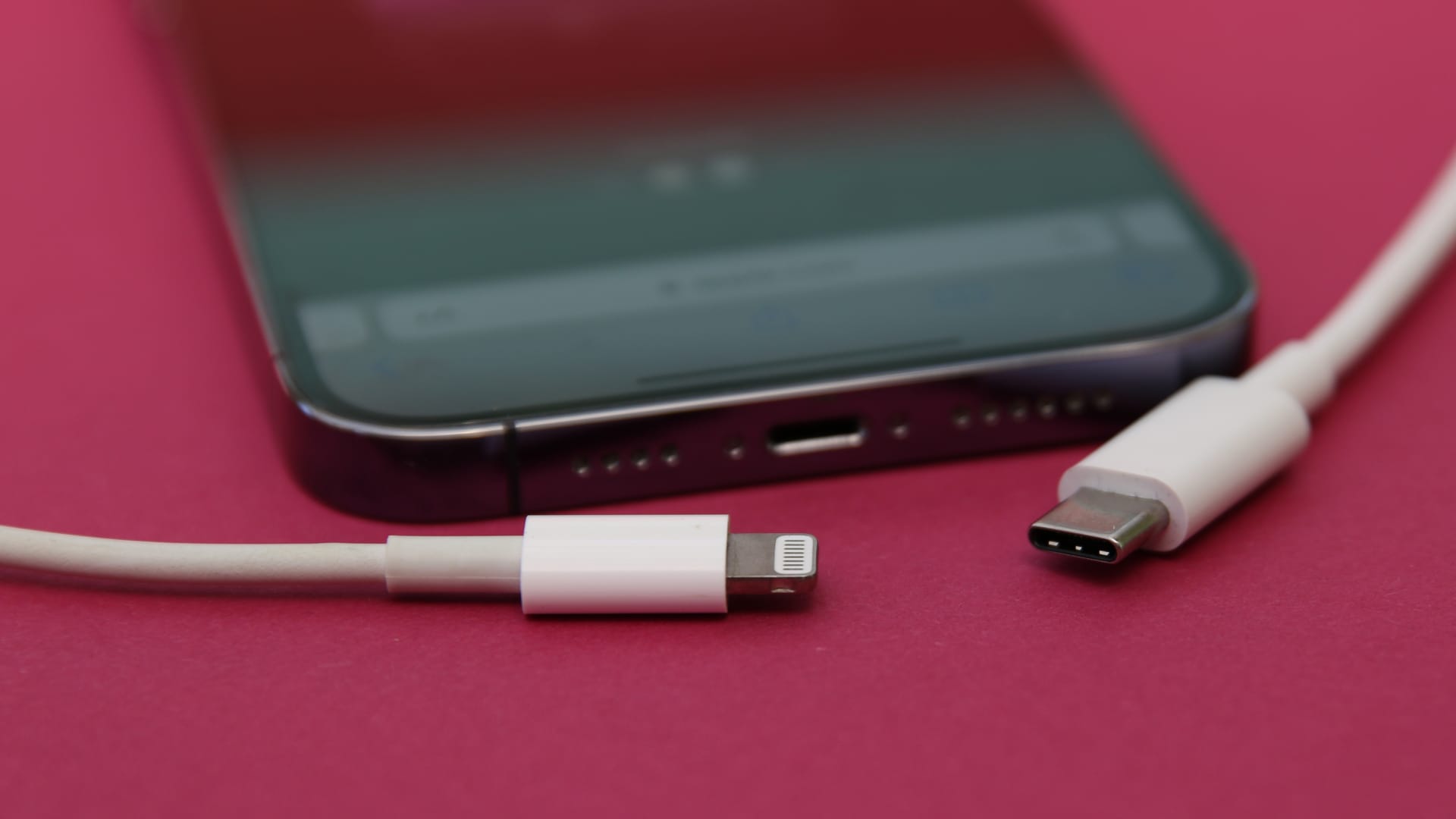 An iPhone 14 Pro with a Lightning cable (left) and a USB-C cable (right). Apple will most likely replace its in-house Lightning connector with USB-C after the European Union decided that phone manufacturers must use the USB-C standard by the end of 2024.