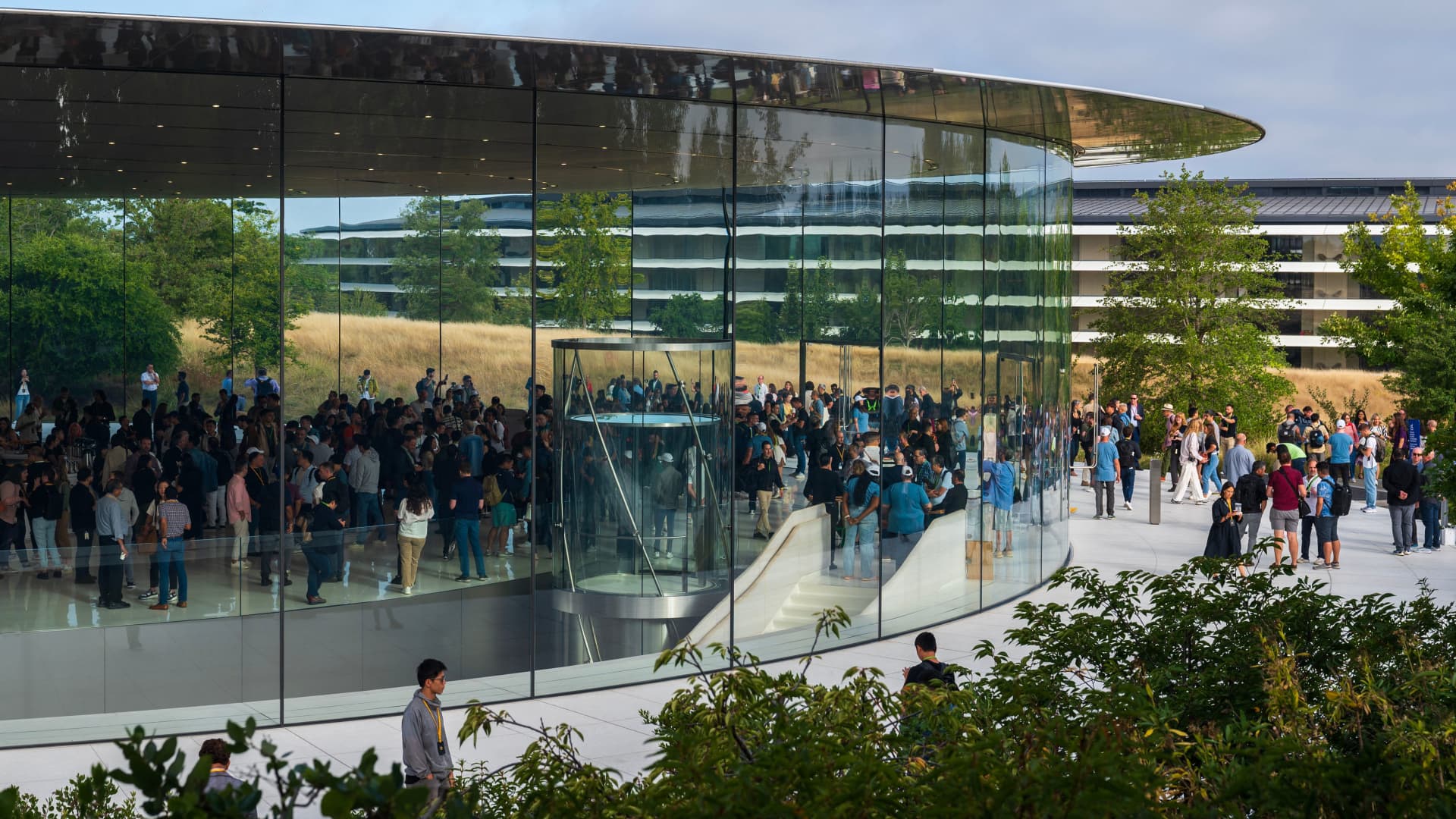 People walk through the Steve Jobs Theater prior to an event at the Apple Park campus in Cupertino, California, on September 12, 2023.