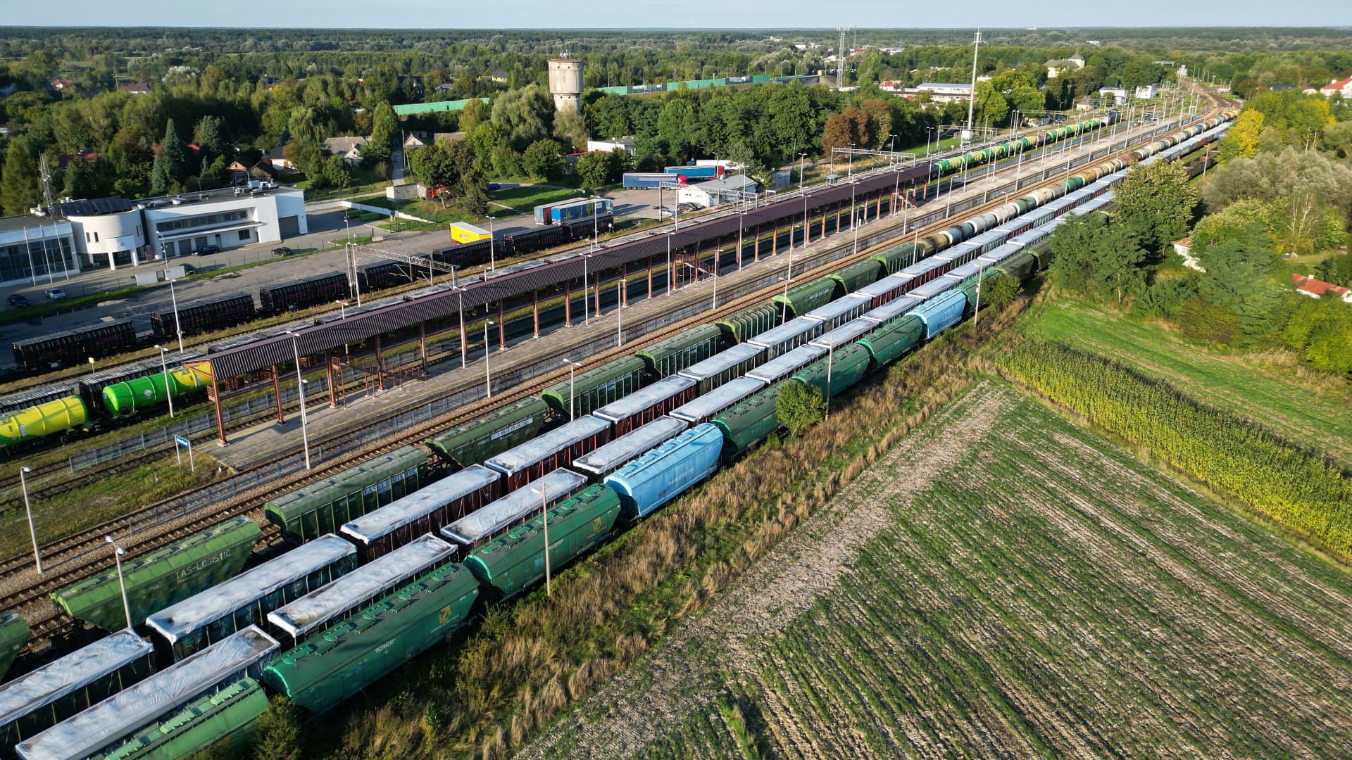 This picture taken on September 20, 2023 shows trains with Ukrainian grain stored in wagons covered with white tarpaulin on the second and third tracks in Dorohusk station at the Polish-Ukrainian border.