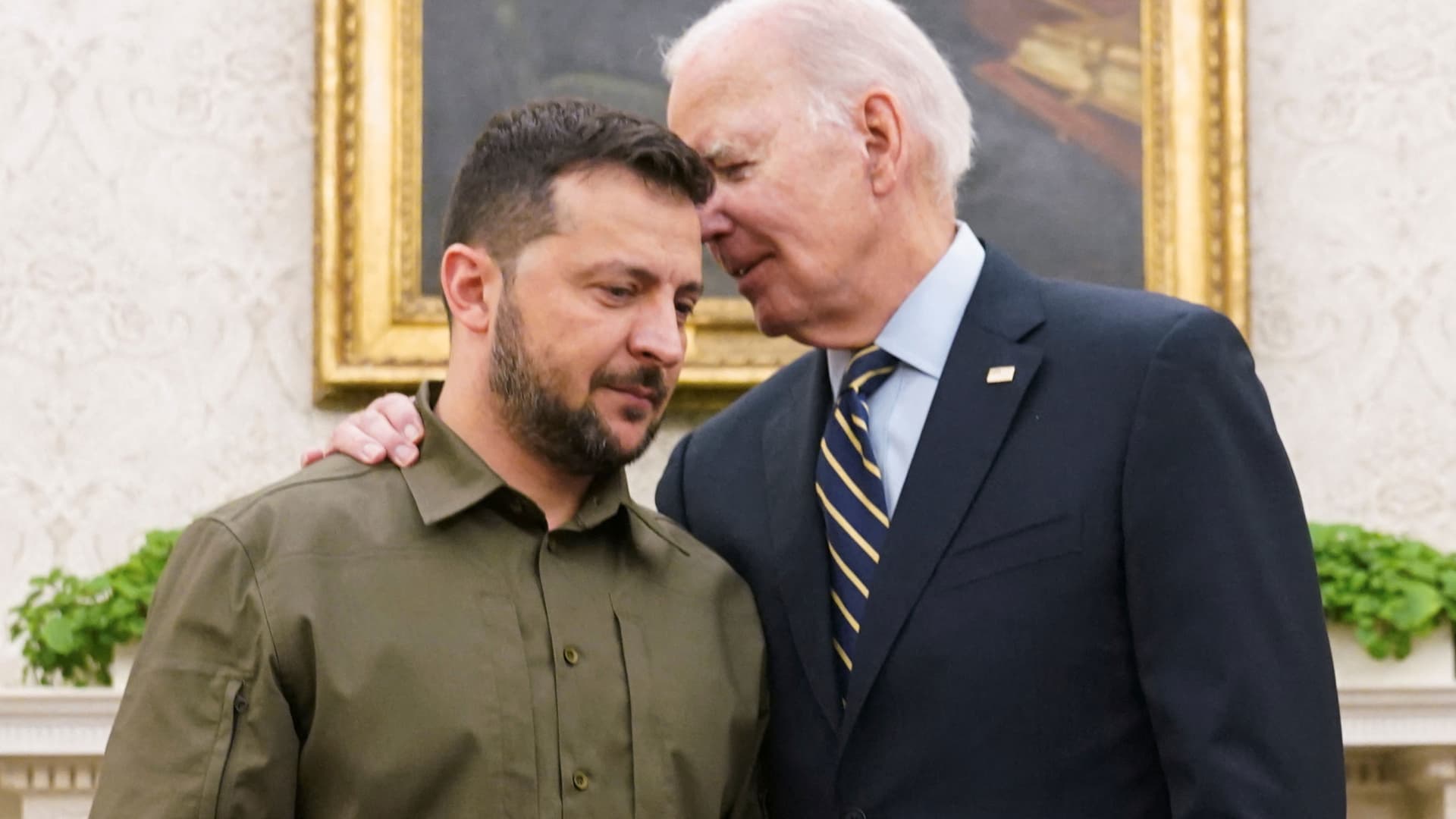 U.S. President Joe Biden puts his arm around Ukrainian President Volodymyr Zelenskyy and whispers to him as they meet in the Oval Office of the White House in Washington, September 21, 2023.
