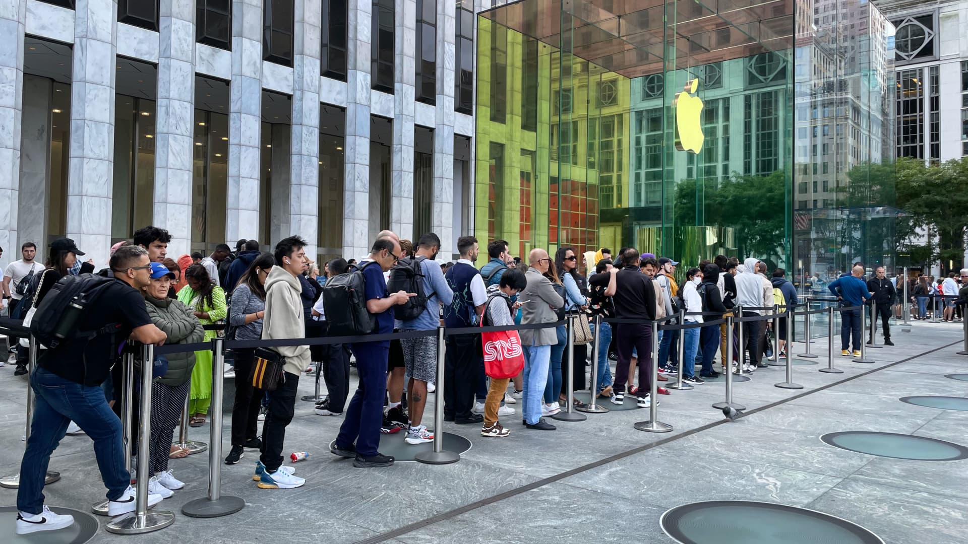 People wait in line to enter an Apple Store in New York, as the iPhone 15 is introduced, September 22, 2023.