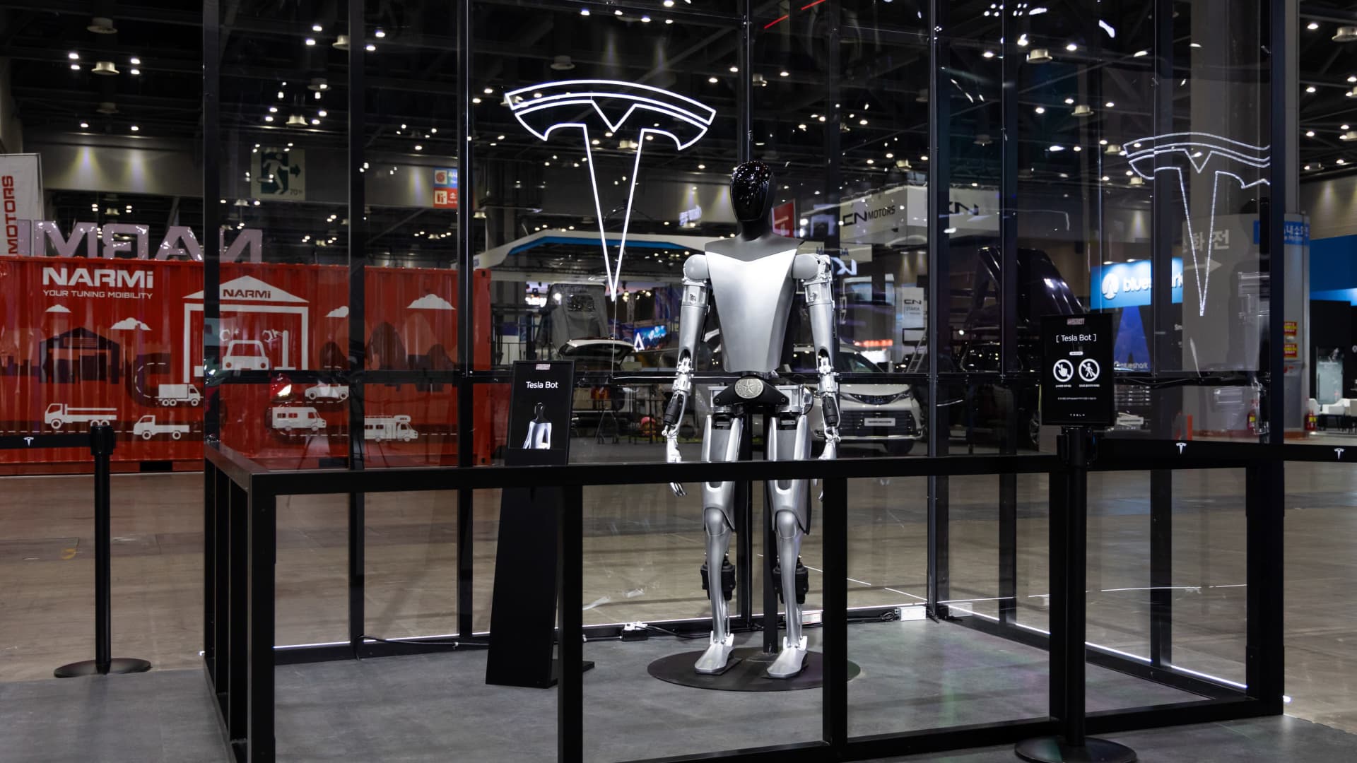 A mockup of Tesla Inc.'s planned humanoid robot Optimus on display during the Seoul Mobility Show in Goyang, South Korea, on Thursday, March 30, 2023. The motor show will continue through April 9. Photographer: SeongJoon Cho/Bloomberg via Getty Images