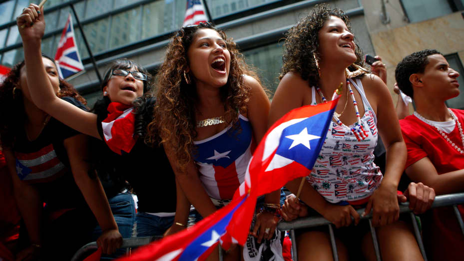 Spectators cheer during Puerto Rican Day Parade in New York. Thousands of people lined both sides of Fifth Avenue for the annual parade, which recognizes the achievements and influence of Puerto Ricans and Latinos in the city.