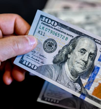 Dollar eases from 10-month high but on track for weekly gain