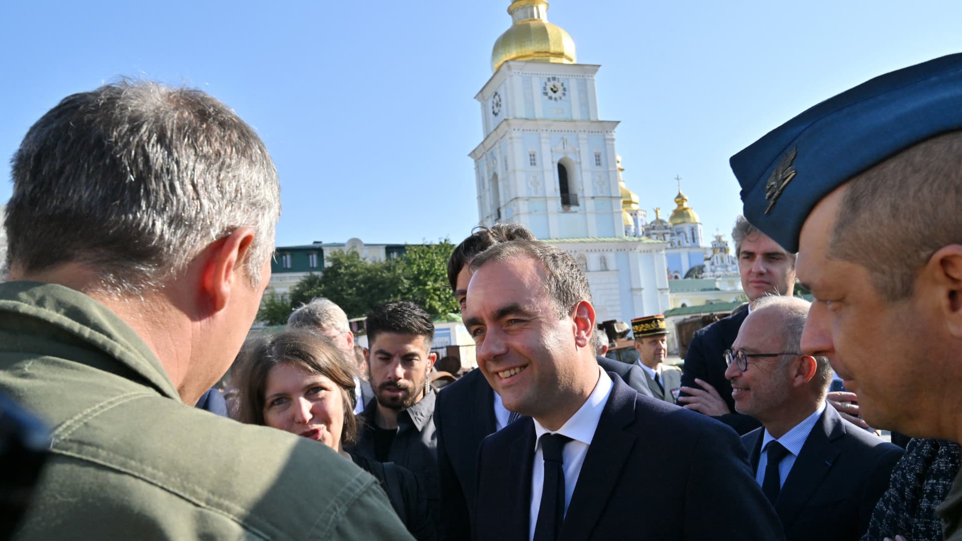 French Armies Minister Sebastien Lecornu (C) addresses the press next to the St. Michael's Golden-Domed cathedral during the Minister's visit in Kyiv on September 28, 2023, amid the Russian invasion of Ukraine.