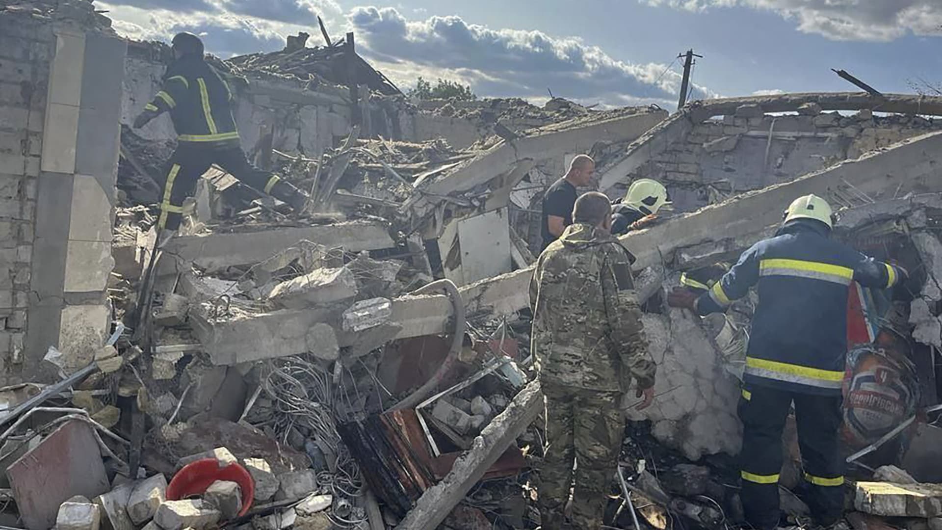 Emergency workers search for victims of a Russian rocket attack in the village of Hroza near Kharkiv, Ukraine, on Oct. 5, 2023.