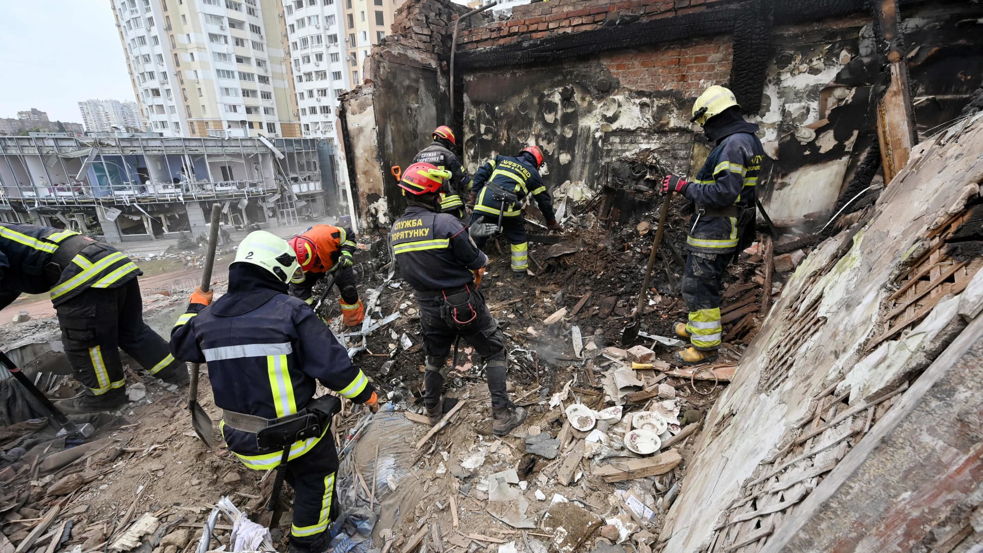 Rescuers clear debris at a destroyed residential building after a Russian missile strike in Kharkiv on Oct. 6, 2023.