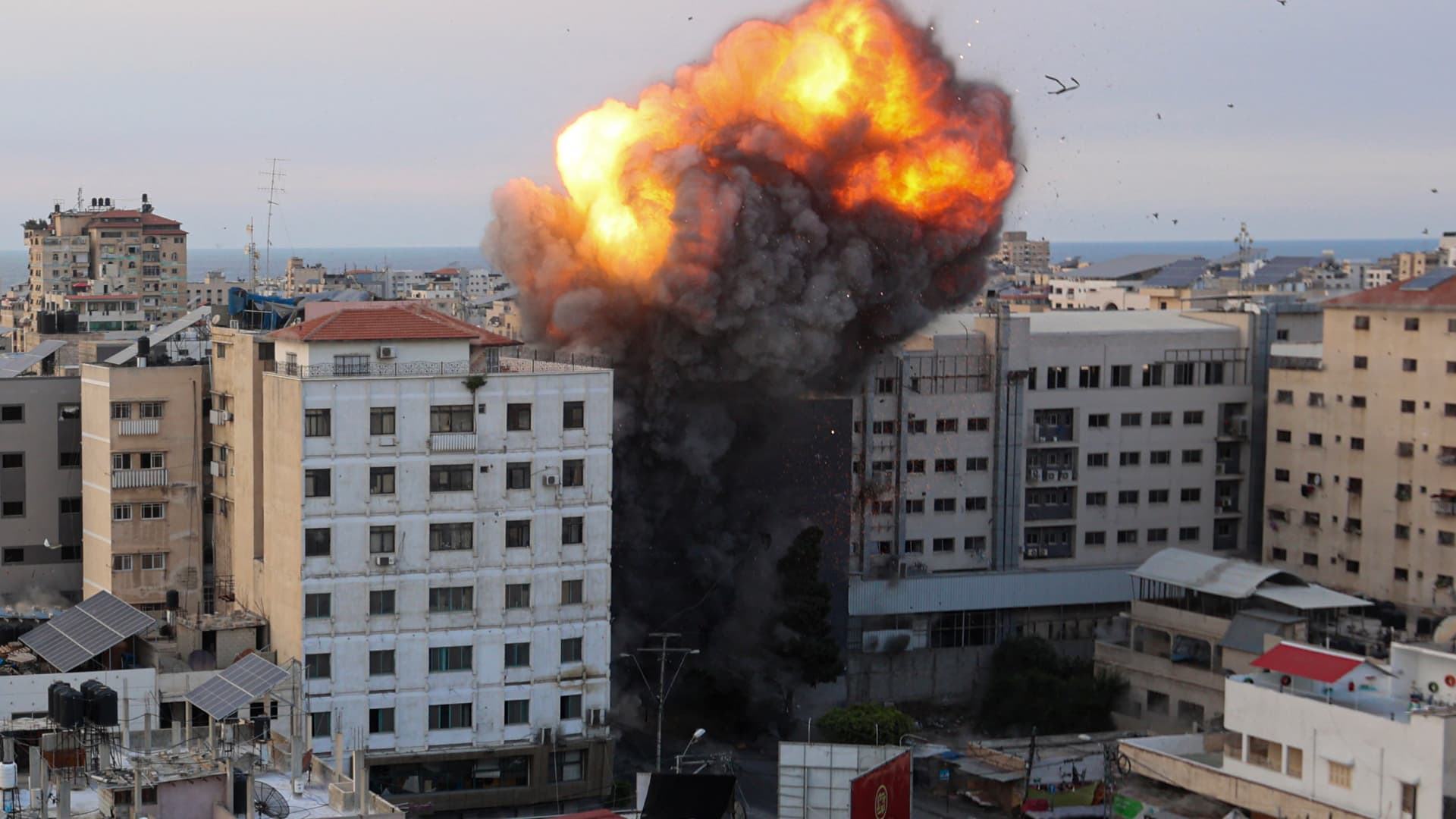 Fire and smoke rise after an Israeli airstrike targeted the National Bank in Gaza City, on Oct. 8, 2023.