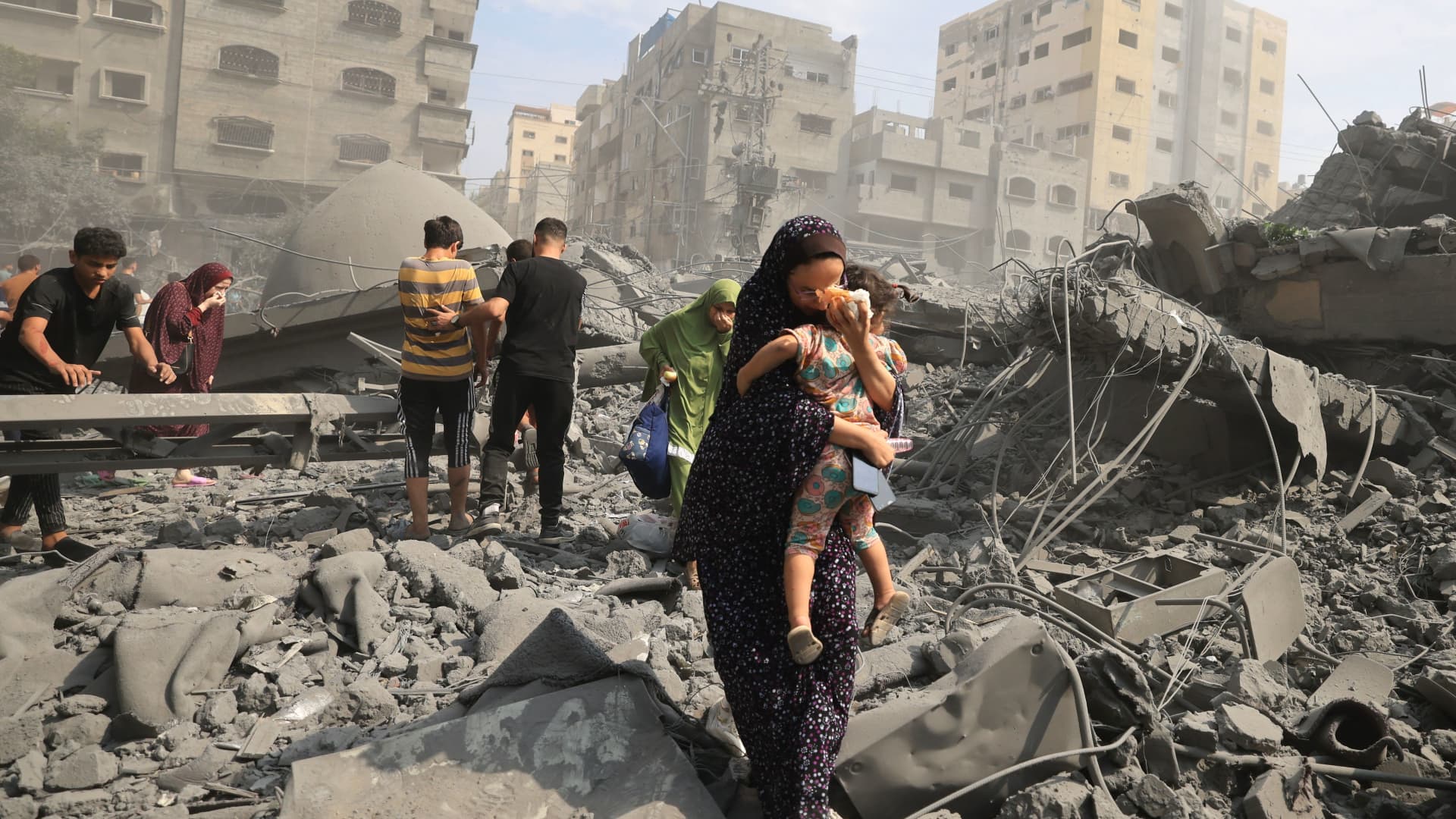 Palestinians evacuate the area following an Israeli airstrike on the Sousi Mosque in Gaza City on Oct. 9, 2023.