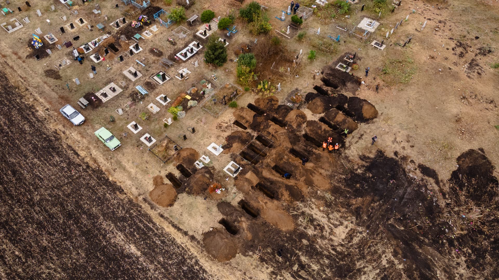 In an aerial view, gravediggers make new graves for the victims of a recent Russian missile strike at Hroza cemetery on October 09, 2023 in Hroza, Ukraine.