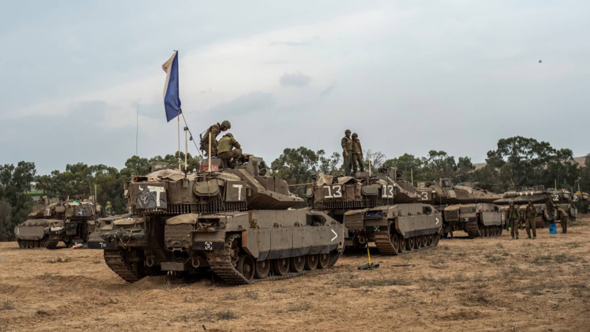 Israeli soldier work on a tank at the Israel-Gaza border.