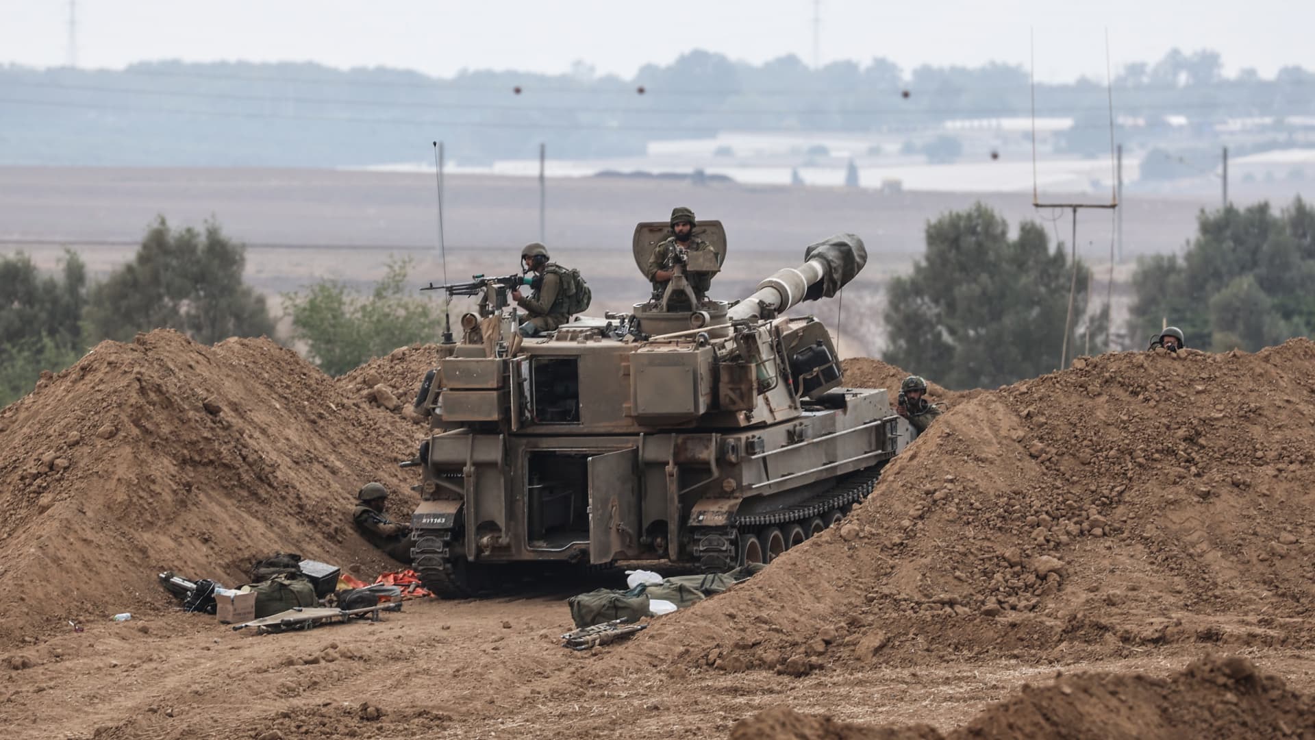 Israeli soldiers on a tank are seen near the Israel-Gaza border. 
