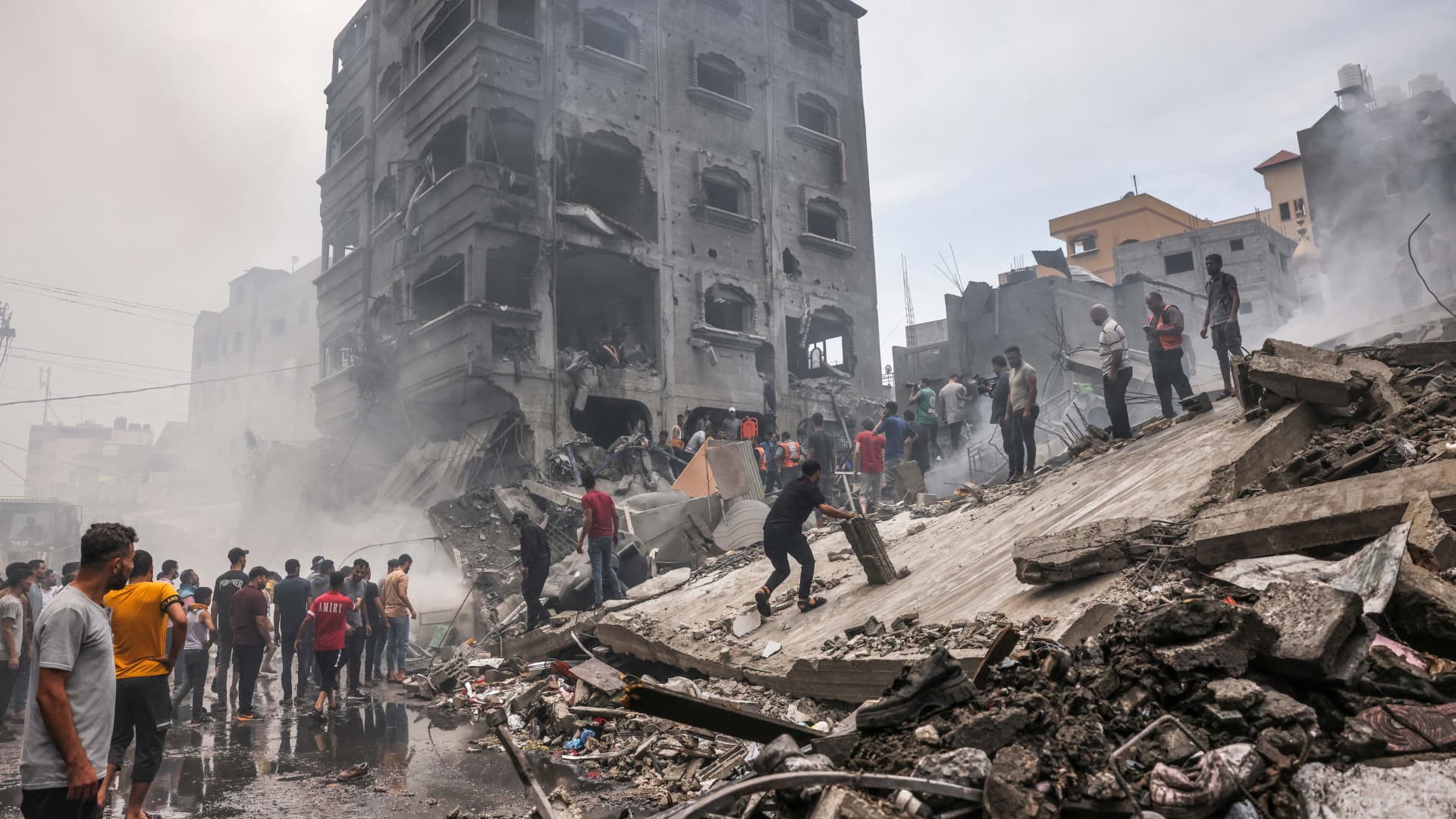Palestinians search for survivors after an Israeli airstrike on buildings in the refugee camp of Jabalia in the Gaza Strip on October 9, 2023.