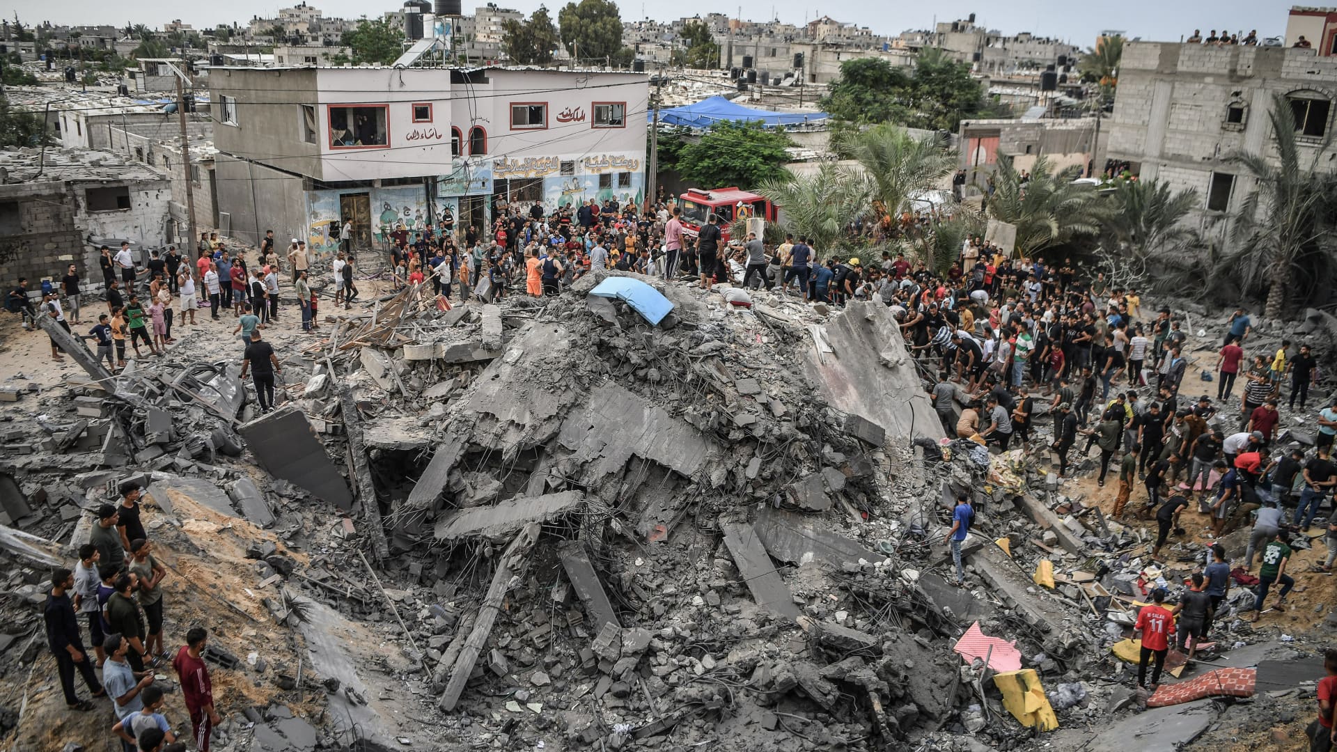 An aerial view of collapsed building as search and rescue efforts continue among rubbles of destroyed buildings aftermath of Israeli airstrikes in Khan Yunis, Gaza on October 09, 2023.