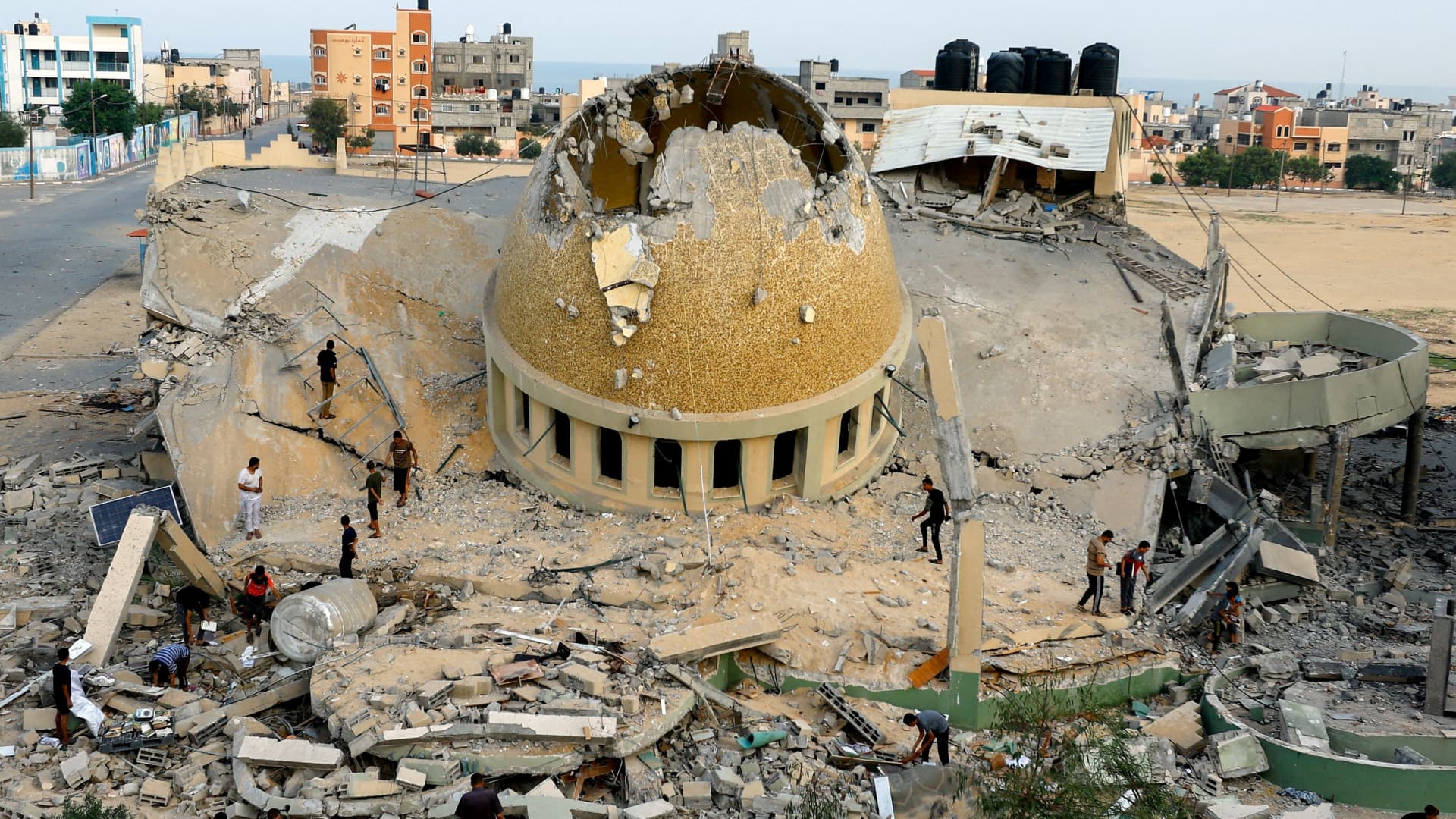 Palestinians inspect a mosque destroyed in Israeli strikes in Khan Younis, in the southern Gaza Strip, October 8, 2023.